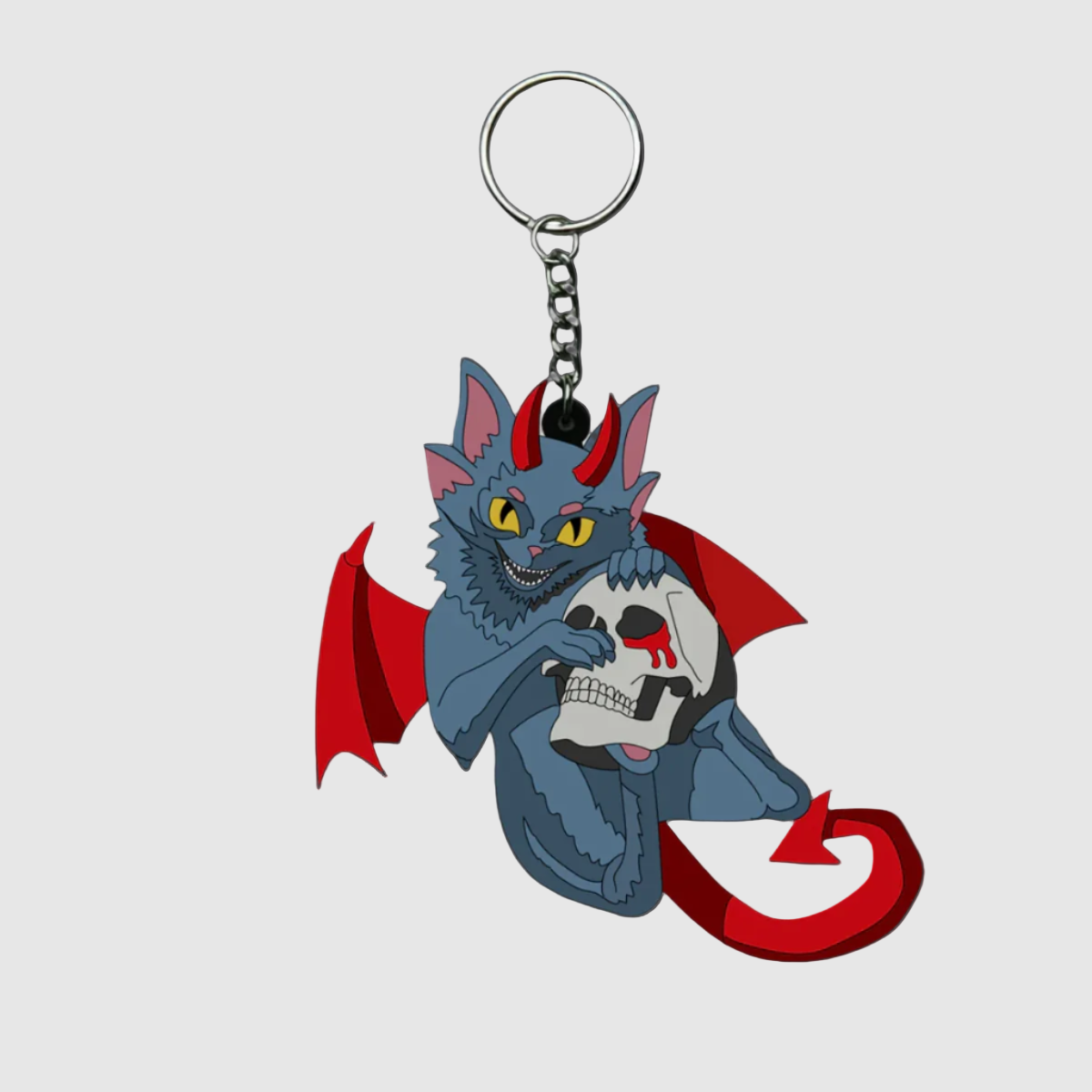 A PVC keychain featuring a stylized cat with bat wings holding a skull.