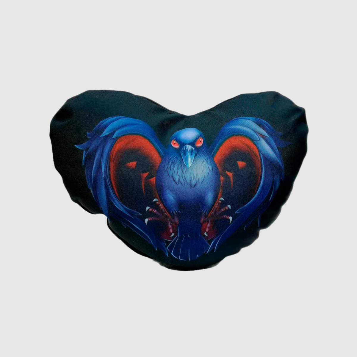 A heart-shaped pillow with a black background featuring a blue and red crow design.