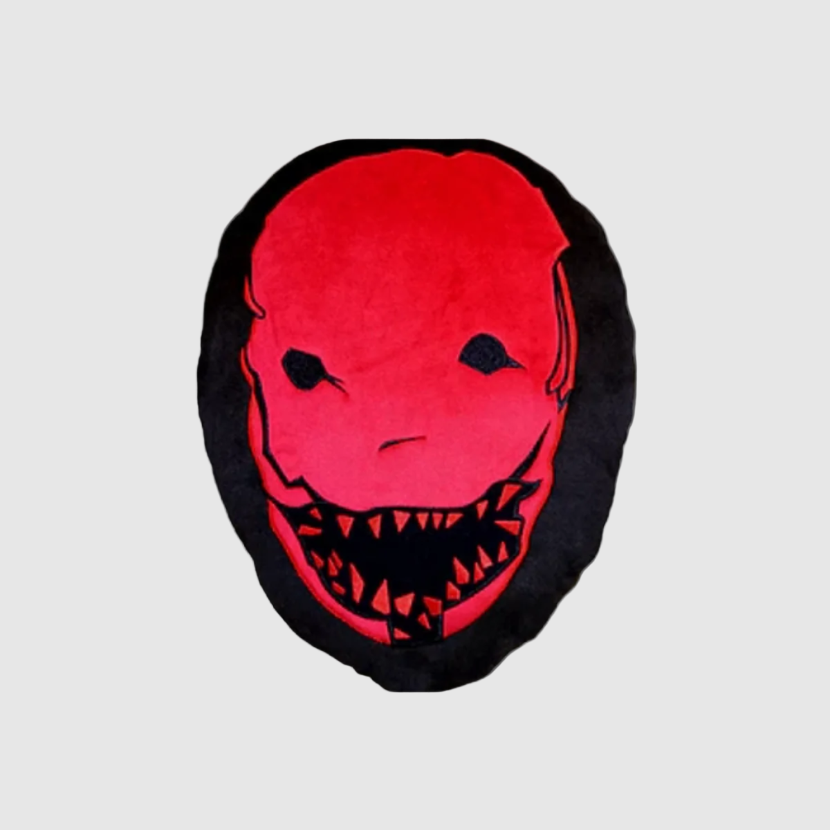 A red throw pillow with The Trapper's mask.