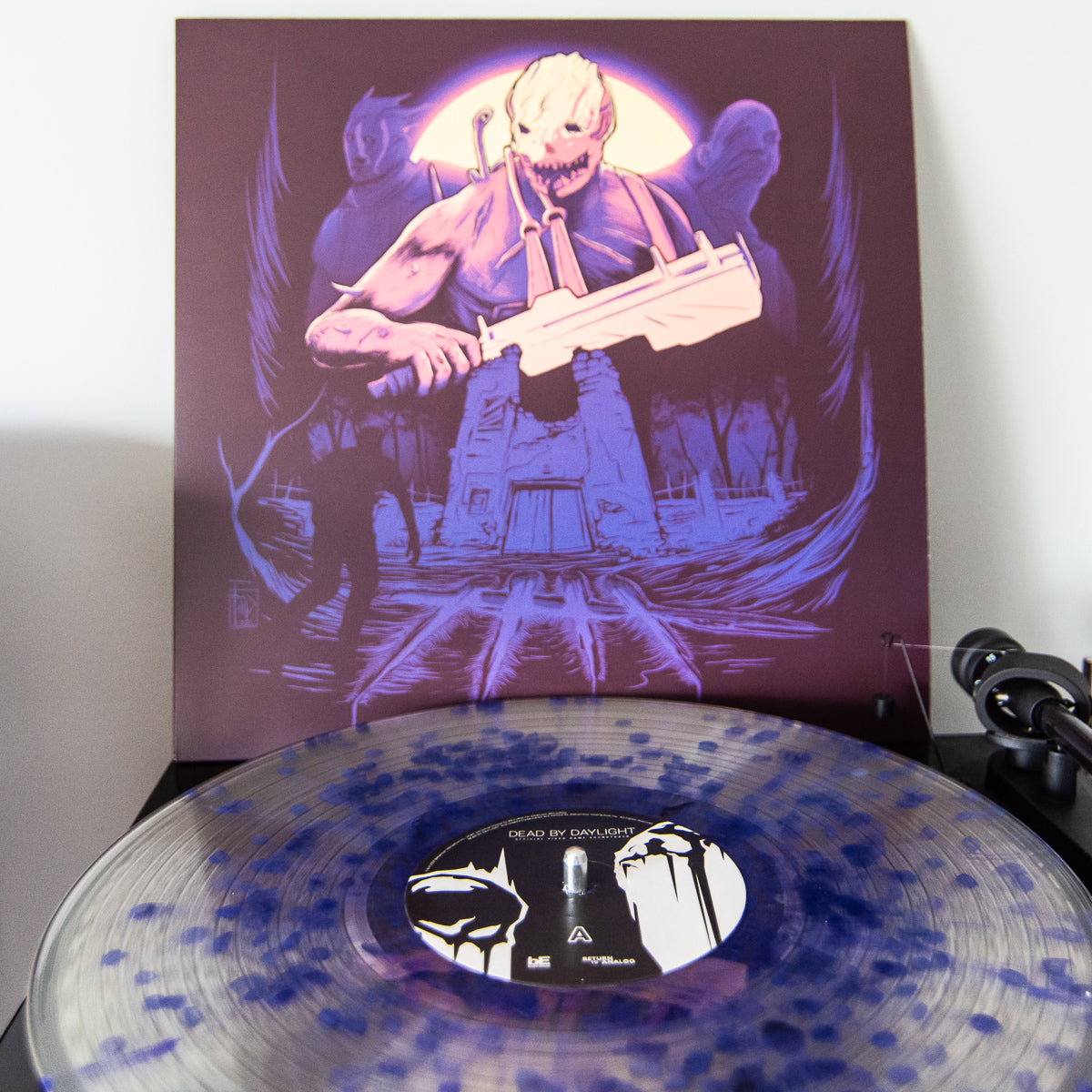 Vinyl record with a cover featuring a stylized illustration of a character holding a machete on a purple background.