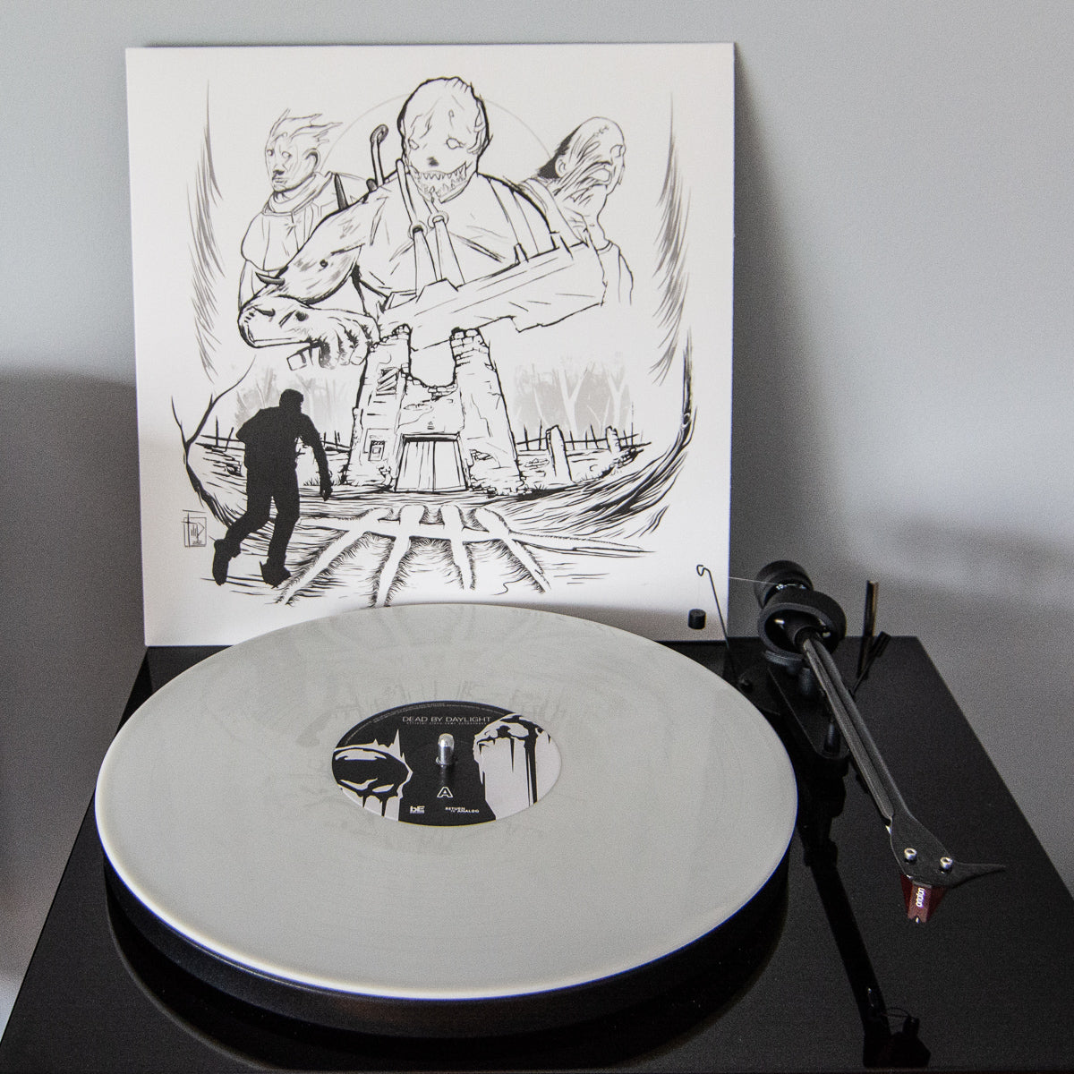 Vinyl record on a turntable with a black and white illustration in the background