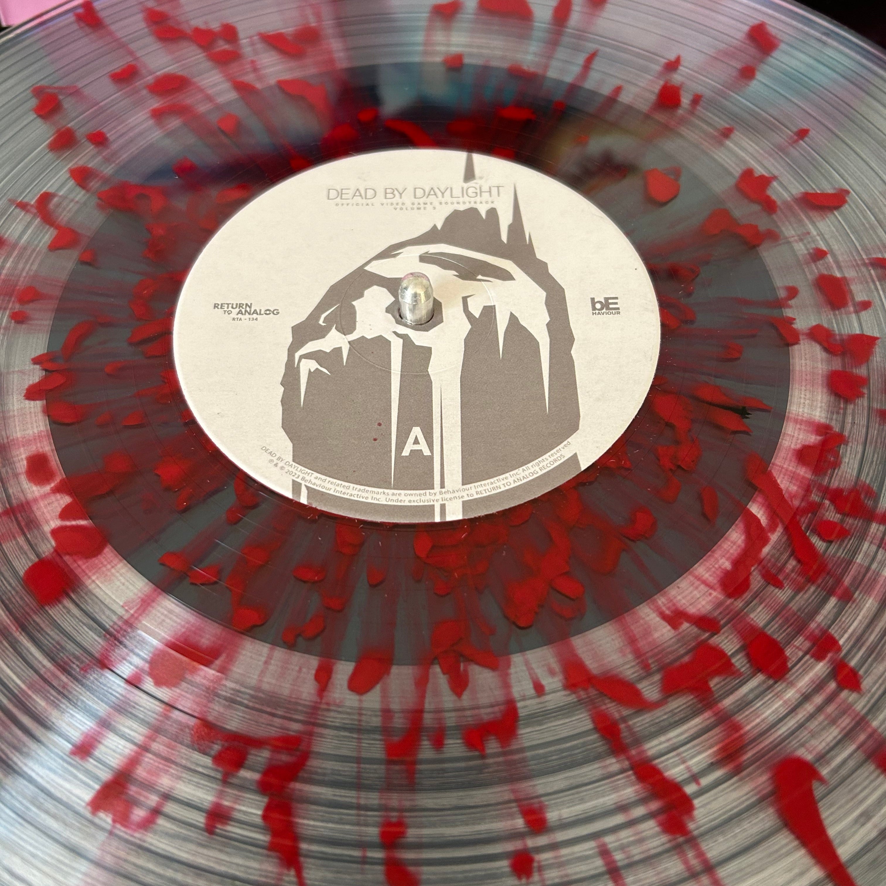 Vinyl record with red splatter design and a central label