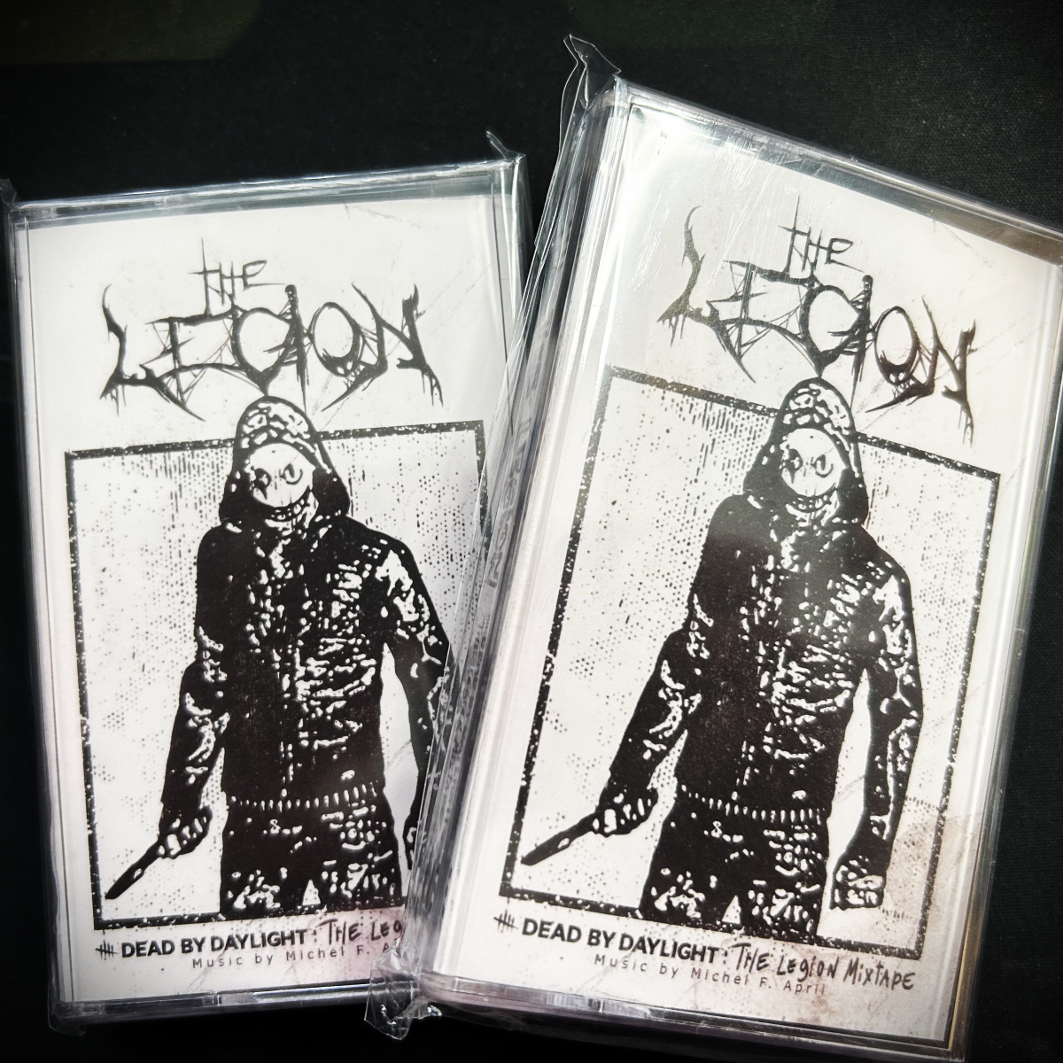 Two cassette tapes with 'The Legion' design on a dark background